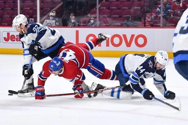 June 6: Paul Byron of the Montreal Canadiens collides with Josh Morrissey of the Winnipeg Jets while Trevor Lewis skates with the puck in Game Three...