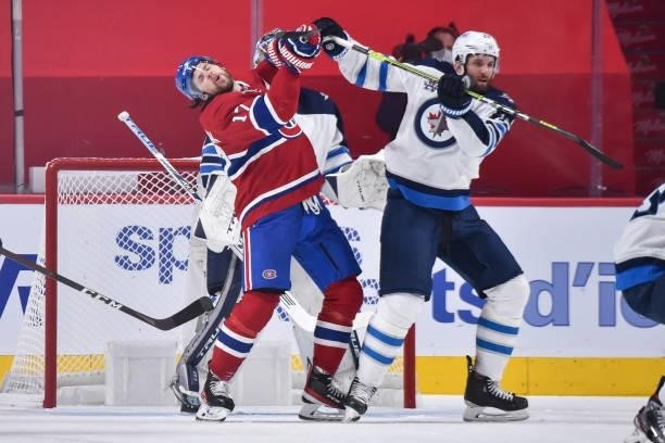 Josh Anderson of the Montreal Canadiens and Derek Forbort of the Winnipeg Jets battle for position during the first period in Game Three of the...