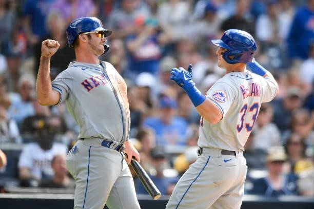 James McCann of the New York Mets is congratulated by Pete Alonso after hitting a two-run home run in the eighth inning against San Diego Padres at...