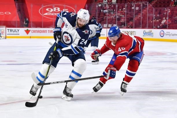 June 6: Joel Armia of the Montreal Canadiens fights for the puck against Derek Forbort of the Winnipeg Jets in Game Three of the Second Round of the...