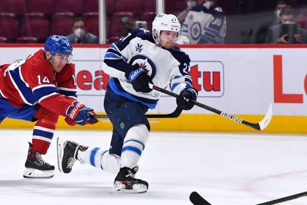 June 6: Nikolaj Ehlers of the Winnipeg Jets fires a shot while being challenged by Nick Suzuki of the Montreal Canadiens in Game Three of the Second...