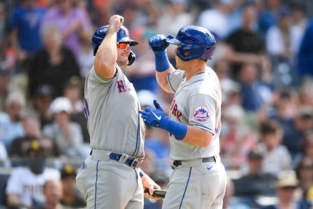 James McCann of the New York Mets is congratulated by Pete Alonso after hitting a two-run home run during the eighth inning against San Diego Padres...
