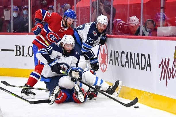 June 6: Nate Thompson and Trevor Lewis of the Winnipeg Jets fight for the puck against Brett Kulak and Ben Chiarot of the Montreal Canadiens in Game...