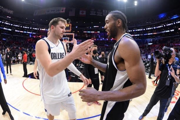 Kawhi Leonard of the LA Clippers and Luka Doncic of the Dallas Mavericks embrace after the game during Round 1, Game 7 of the 2021 NBA Playoffs on...