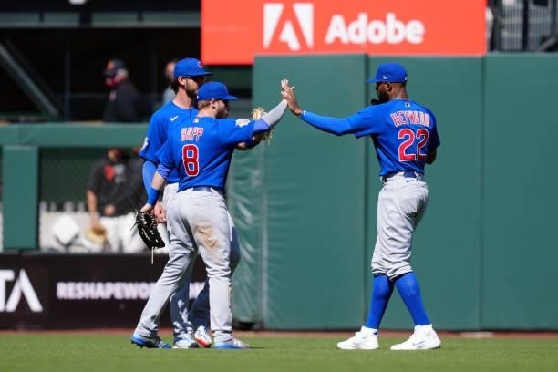 Kris Bryant of the Chicago Cubs, Ian Happ, and Jason Heyward celebrate after the game between the Chicago Cubs and the San Francisco Giants at Oracle...