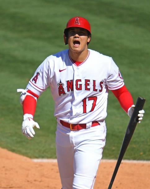 Shohei Ohtani of the Los Angeles Angels returns to the dugout after striking out in the seventh inning of the game against the Seattle Mariners at...