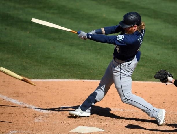 Jake Fraley of the Seattle Mariners breaks his bat on a single in the ninth inning against the Los Angeles Angels at Angel Stadium of Anaheim on June...