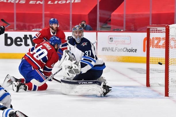 Joel Armia of the Montreal Canadiens scores on goaltender Connor Hellebuyck of the Winnipeg Jets during the second period in Game Three of the Second...