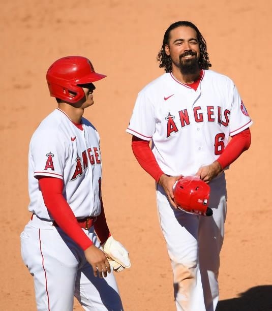 Shohei Ohtani talks with Anthony Rendon of the Los Angeles Angels during a pitching change in the ninth inning against the Seattle Mariners at Angel...