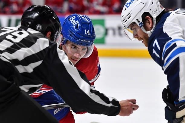 Nick Suzuki of the Montreal Canadiens prepares to face-off against Adam Lowry of the Winnipeg Jets during the second period in Game Three of the...