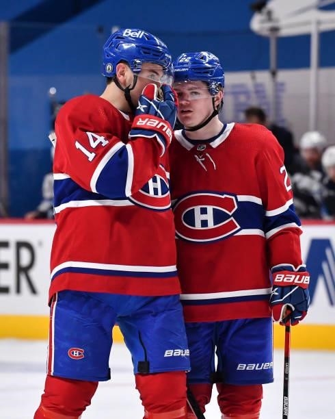 Nick Suzuki and Cole Caufield of the Montreal Canadiens speak during the second period against the Winnipeg Jets in Game Three of the Second Round of...