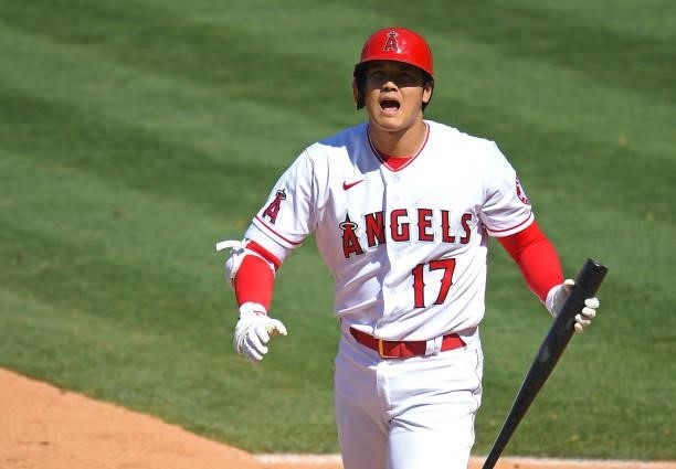 Shohei Ohtani of the Los Angeles Angels returns to the dugout after striking out in the seventh inning of the game against the Seattle Mariners at...