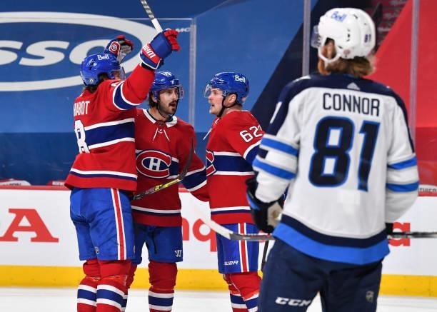 Artturi Lehkonen of the Montreal Canadiens celebrates his goal with teammates Ben Chiarot and Phillip Danault against the Winnipeg Jets during the...
