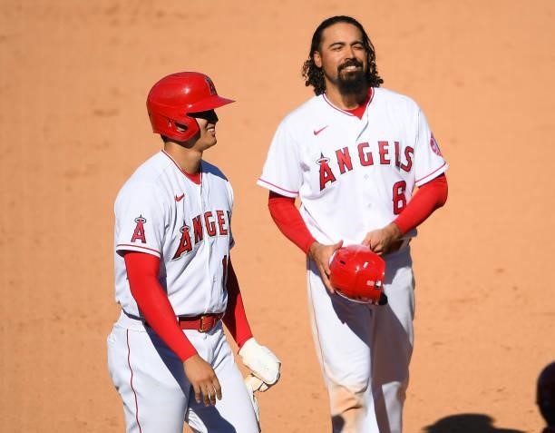 Shohei Ohtani talks with Anthony Rendon of the Los Angeles Angels during a pitching change in the ninth inning against the Seattle Mariners at Angel...