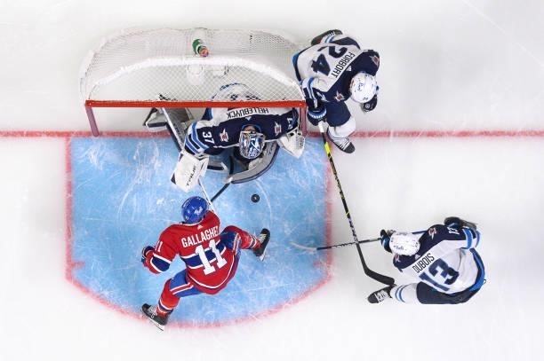 June 6: Brendan Gallagher of the Montreal Canadiens attempts to score on goaltender Connor Hellebuyck of the Winnipeg Jets in Game Three of the...