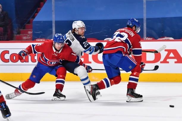 Nick Suzuki of the Montreal Canadiens defends against Mason Appleton of the Winnipeg Jets during the third period in Game Three of the Second Round...