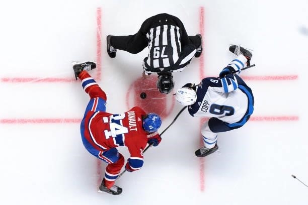June 6: Phillip Danault of the Montreal Canadiens faces off against Andrew Copp of the Winnipeg Jets in Game Three of the Second Round of the 2021...