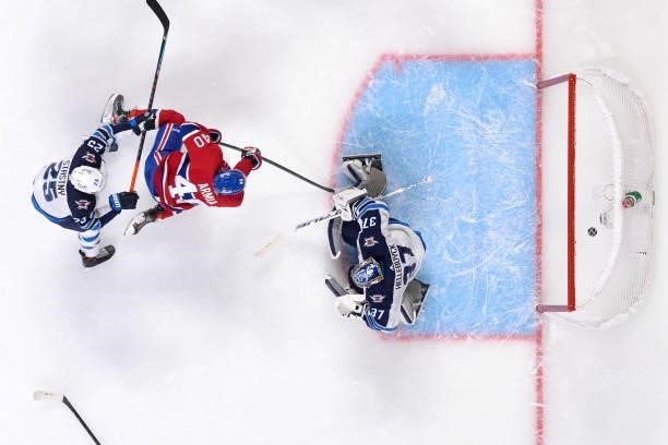June 6: Joel Armia of the Montreal Canadiens scores a goal on goaltender Connor Hellebuyck of the Winnipeg Jets in Game Three of the Second Round of...