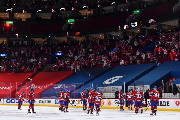 The Montreal Canadiens celebrate their victory against the Winnipeg Jets as fans cheer them on in Game Three of the Second Round of the 2021 Stanley...