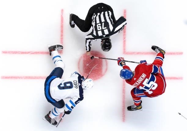 June 6: Jesperi Kotkaniemi of the Montreal Canadiens faces off against Andrew Copp of the Winnipeg Jets in Game Three of the Second Round of the 2021...