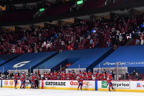 Nick Suzuki of the Montreal Canadiens celebrates his goal with teammates on the bench as fans cheer on against the Winnipeg Jets during the third...