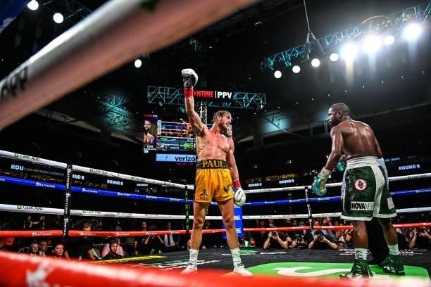 YouTube personality Logan Paul raises his glove as he fights Former world welterweight king Floyd Mayweather in an eight-round exhibition bout at...