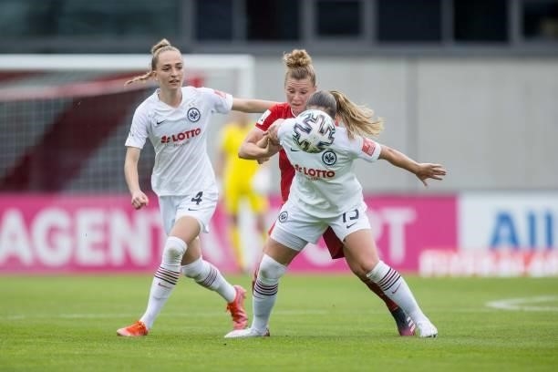 Linda Dallmann of FC Bayern Munich and Sandrine Mauron of Eintracht Frankfurt battle for the ball during the FLYERALARM Frauen Bundesliga match...
