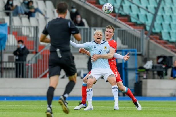 Lyndon Dykes of Scotland and Enes Mahmutovic of Luxembourg battle for the ball during the international friendly match between Luxembourg and...