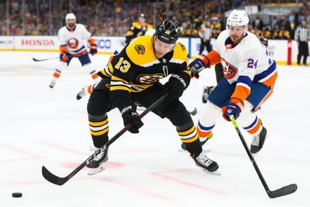 Charlie Coyle of the Boston Bruins and Scott Mayfield of the New York Islanders fight for the puck in Game Five of the Second Round of the 2021...