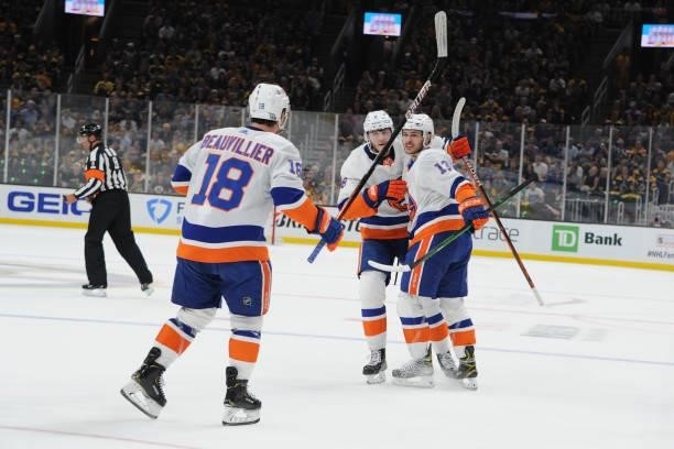 Anthony Beauvillier, Noah Dobson and Mathew Barzal of the New York Islanders celebrate the first period goal against the Boston Bruins in Game Five...