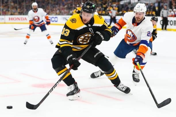 Charlie Coyle of the Boston Bruins and Scott Mayfield of the New York Islanders fight for the puck in Game Five of the Second Round of the 2021...
