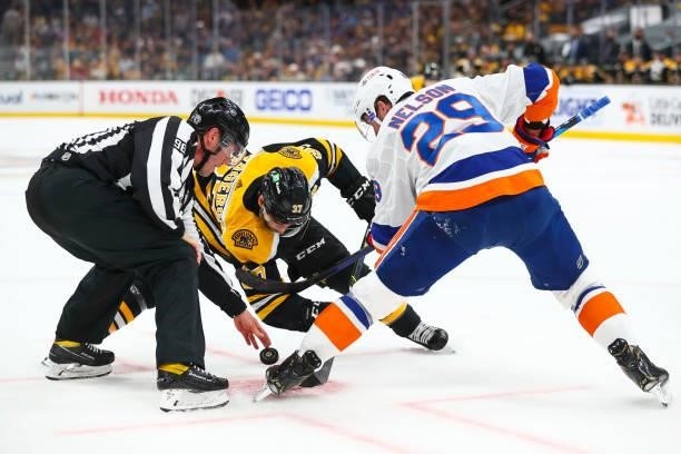Linesman David Brisebois initiates a face-off between Patrice Bergeron of the Boston Bruins and Brock Nelson of the New York Islanders in Game Five...