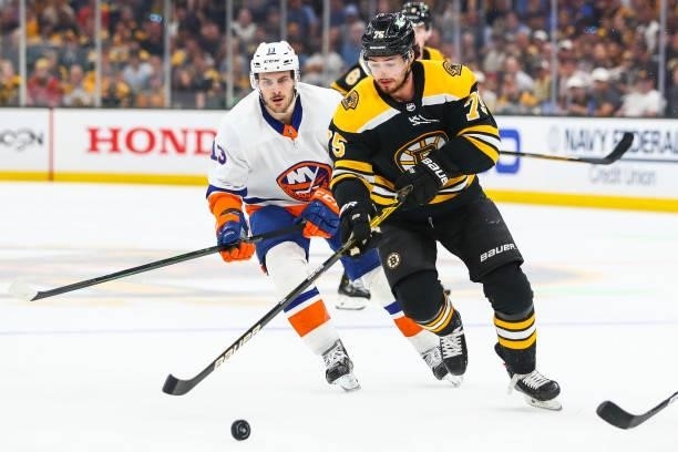 Connor Clifton of the Boston Bruins and Mathew Barzal of the New York Islanders fight for the puck in Game Five of the Second Round of the 2021...
