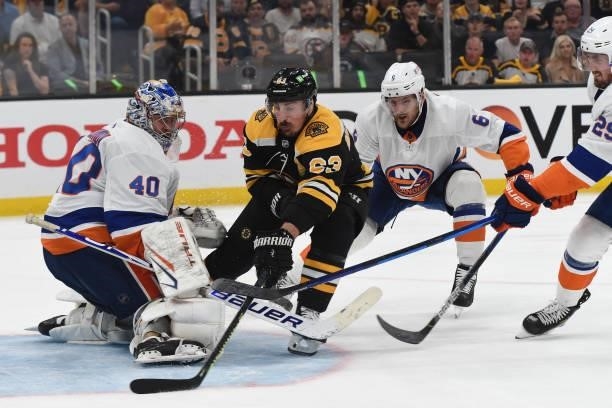 Brad Marchand of the Boston Bruins against Semyon Varalmov and Ryan Pulock the New York Islanders in Game Five of the Second Round of the 2021...