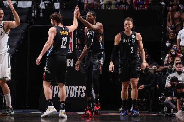 Joe Harris of the Brooklyn Nets high fives Kevin Durant of the Brooklyn Nets during Round 2, Game 2 of the 2021 NBA Playoffs on June 7, 2021 at...