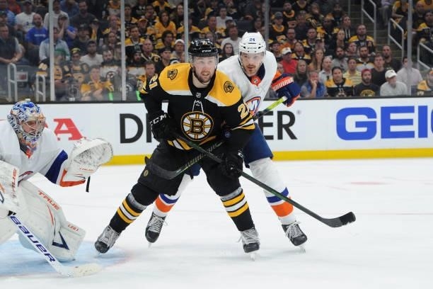 Nick Ritchie of the Boston Bruins against Scott Mayfield of the New York Islanders in Game Five of the Second Round of the 2021 Stanley Cup Playoffs...