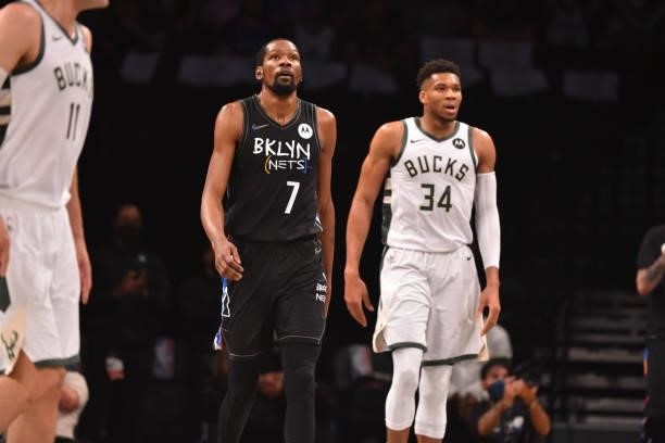 Kevin Durant of the Brooklyn Nets and Giannis Antetokounmpo of the Milwaukee Bucks look on during Round 2, Game 2 on June 7, 2021 at Barclays Center...