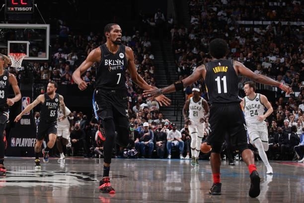 Kevin Durant of the Brooklyn Nets high fives Kyrie Irving of the Brooklyn Nets during Round 2, Game 2 of the 2021 NBA Playoffs on June 7, 2021 at...