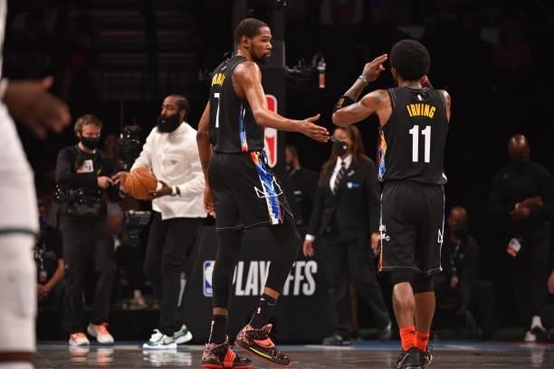 Kevin Durant of the Brooklyn Nets and Kyrie Irving of the Brooklyn Nets high-five during a game against the Milwaukee Bucks during Round 2, Game 2 on...
