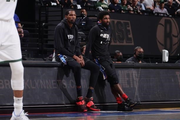 Kevin Durant of the Brooklyn Nets and Kyrie Irving of the Brooklyn Nets looks on during Round 2, Game 2 of the 2021 NBA Playoffs on June 7, 2021 at...
