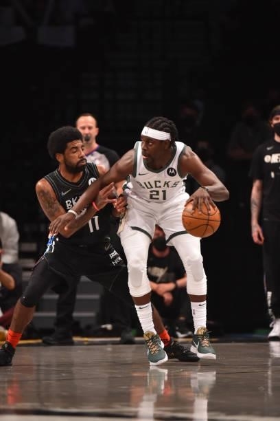 Jrue Holiday of the Milwaukee Bucks handles the ball against Kyrie Irving of the Brooklyn Nets during Round 2, Game 2 on June 7, 2021 at Barclays...