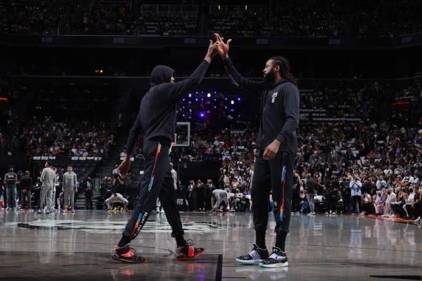 DeAndre Jordan of the Brooklyn Nets high fives Kevin Durant of the Brooklyn Nets before the game against the Milwaukee Bucks during Round 2, Game 2...