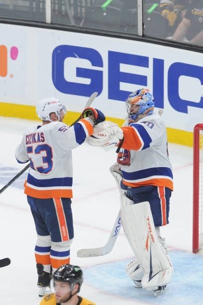 Casey Cizikas and Semyon Varlamov of the New York Islanders celebrate the win against the Boston Bruins in Game Five of the Second Round of the 2021...