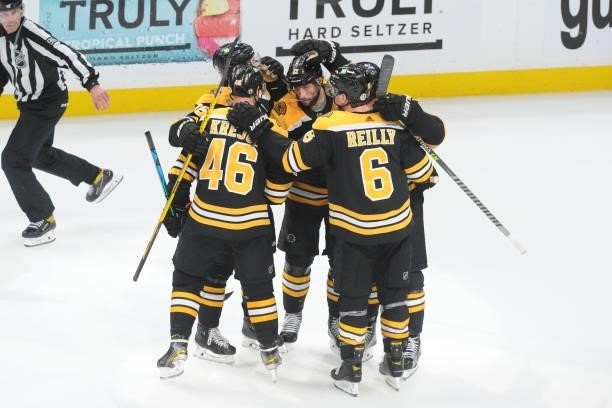David Krejci of the Boston Bruins hugs his line mates after scoring in the third period against the New York Islanders in Game Five of the Second...