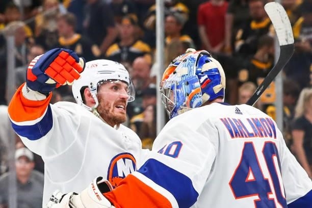 Casey Cizikas embraces Semyon Varlamov of the New York Islanders after a win over the Boston Bruins in Game Five of the Second Round of the 2021...