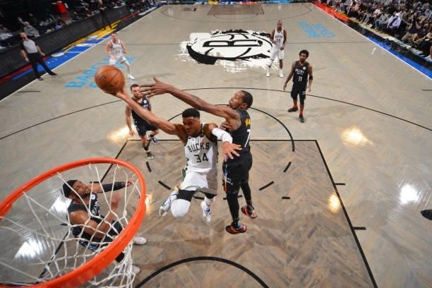 Giannis Antetokounmpo of the Milwaukee Bucks shoots the ball against Kevin Durant of the Brooklyn Nets during Round 2, Game 2 on June 7, 2021 at...