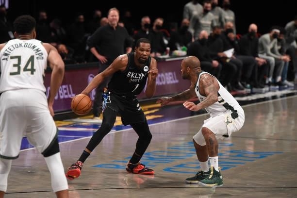 Kevin Durant of the Brooklyn Nets handles the ball against P.J. Tucker of the Milwaukee Bucks during Round 2, Game 2 on June 7, 2021 at Barclays...