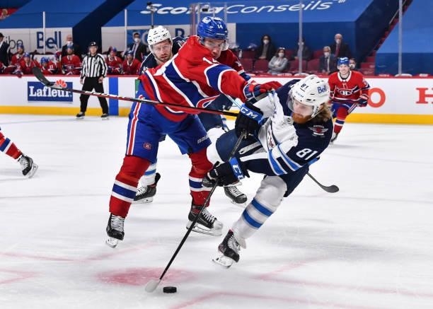 Nick Suzuki of the Montreal Canadiens pushes Kyle Connor of the Winnipeg Jets during the second period in Game Four of the Second Round of the 2021...