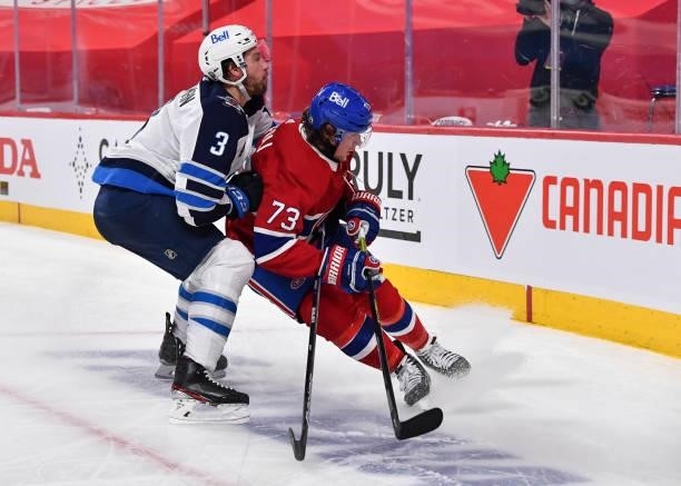 Tucker Poolman of the Winnipeg Jets and Tyler Toffoli of the Montreal Canadiens skate against each other during the second period in Game Four of the...