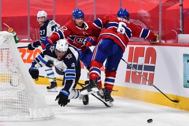 Artturi Lehkonen of the Montreal Canadiens takes down Andrew Copp of the Winnipeg Jets during the third period in Game Four of the Second Round of...
